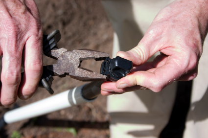 Irrigation contractor in Milpitas CA tightens a sprinkler head